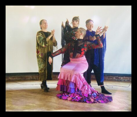 Four members of the colectiva pose with a white backdrop behind them. They wear colorful costumes and pose confidently. Photo courtesy of the artist. 