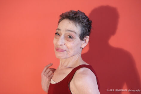 Profile of Barbara Mahler; head, neck and shoulders, she is holding a necklace in her righthand/upstage hand. Photo by Julie Lemberger