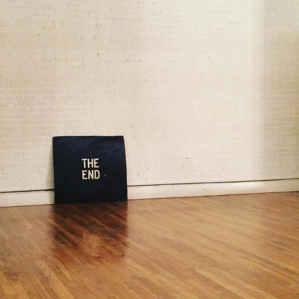 Image of a black canvas, reading 