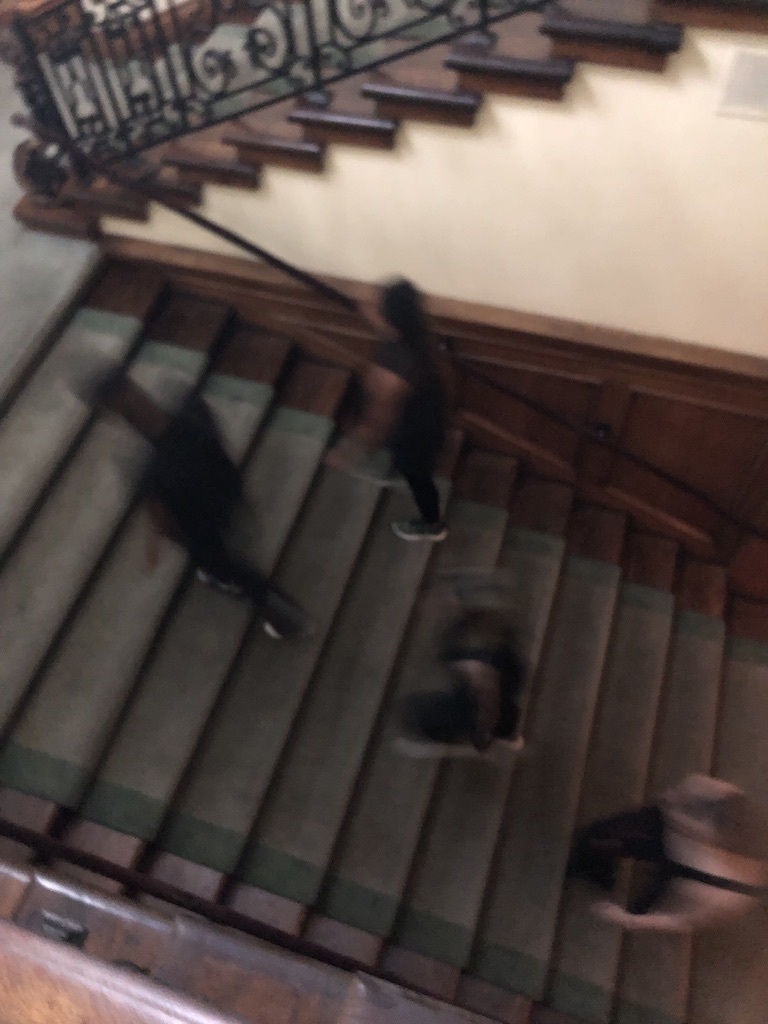 Blurry image of people walking up stairs. 