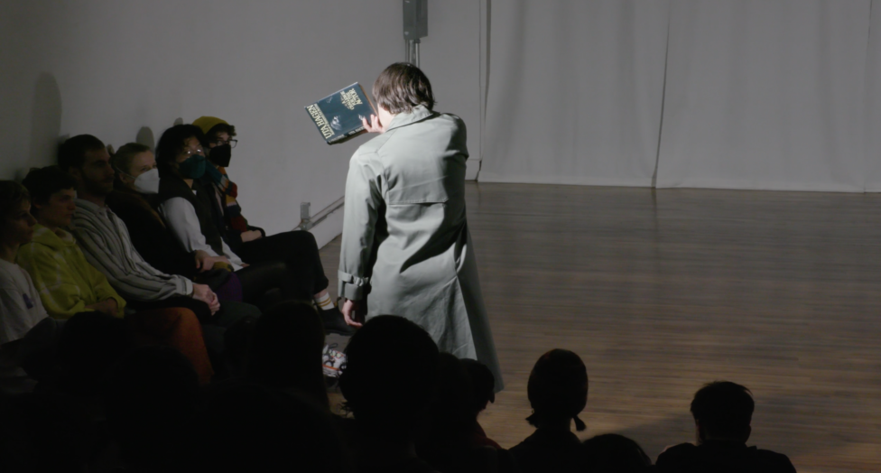 Wearing a grey trench coat, Tess Dworman holds Uta Hagen's 