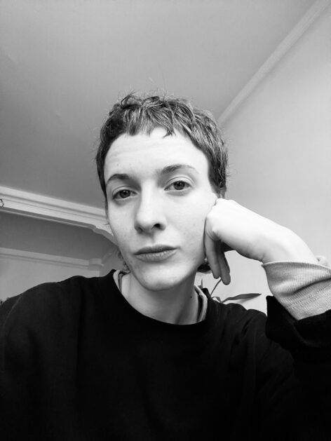 It's a black and white selfie photo of a woman with a short haircut. Soňa is gently leaning on her hand and looking into the camera in her neutral gaze. Photo courtesy of the artist.