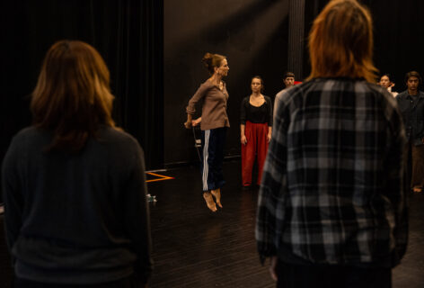 2024, 7/12: Summer MELT, Shelley Senter: Shelley mid air with her hands behind her back, students watch her in action. Photo by Rachel Keane.
