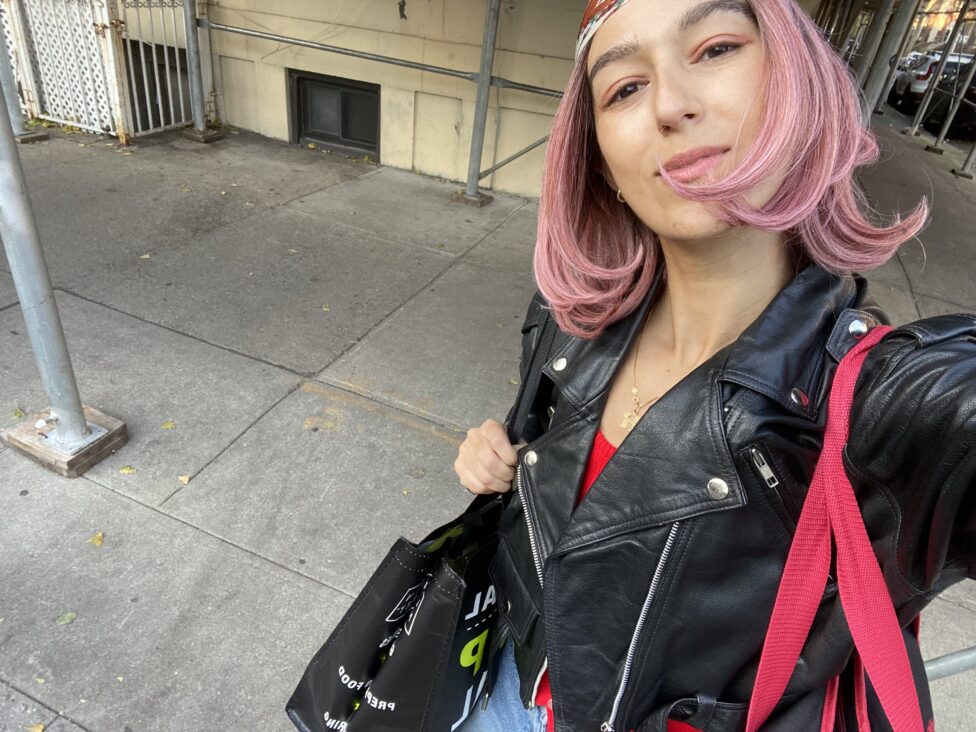 The infamous pink wig — Roya, taking a selfie, wearing a pink wig.